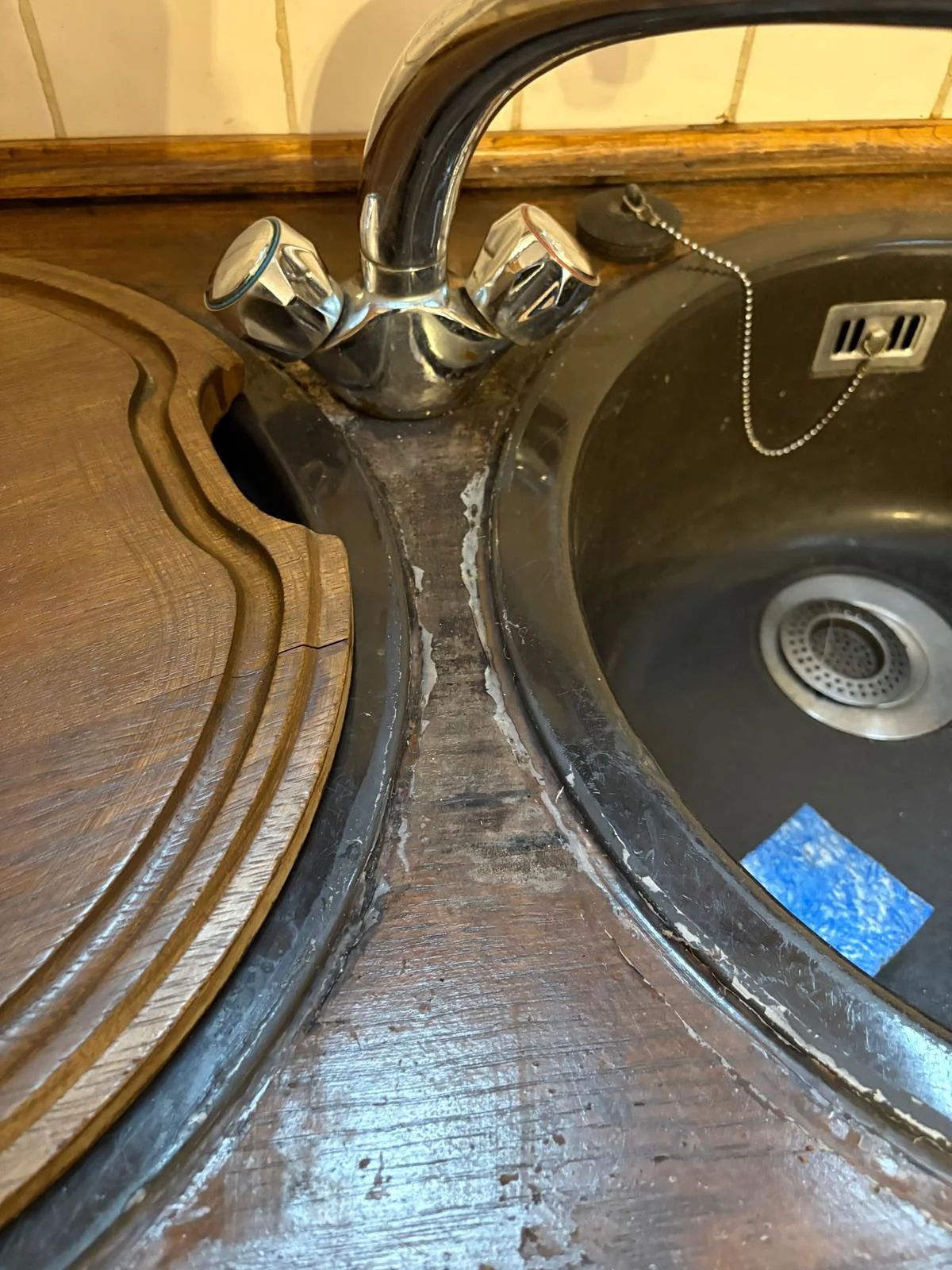 Deteriorating sink surround seal in a holiday let kitchen